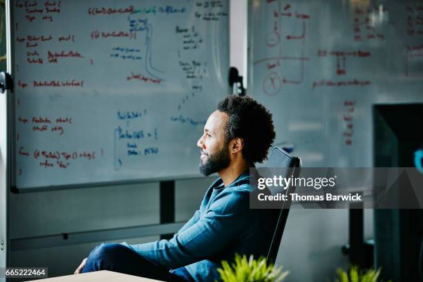 smiling engineer at workstation in high tech office - design thinking stock-fotos und bilder