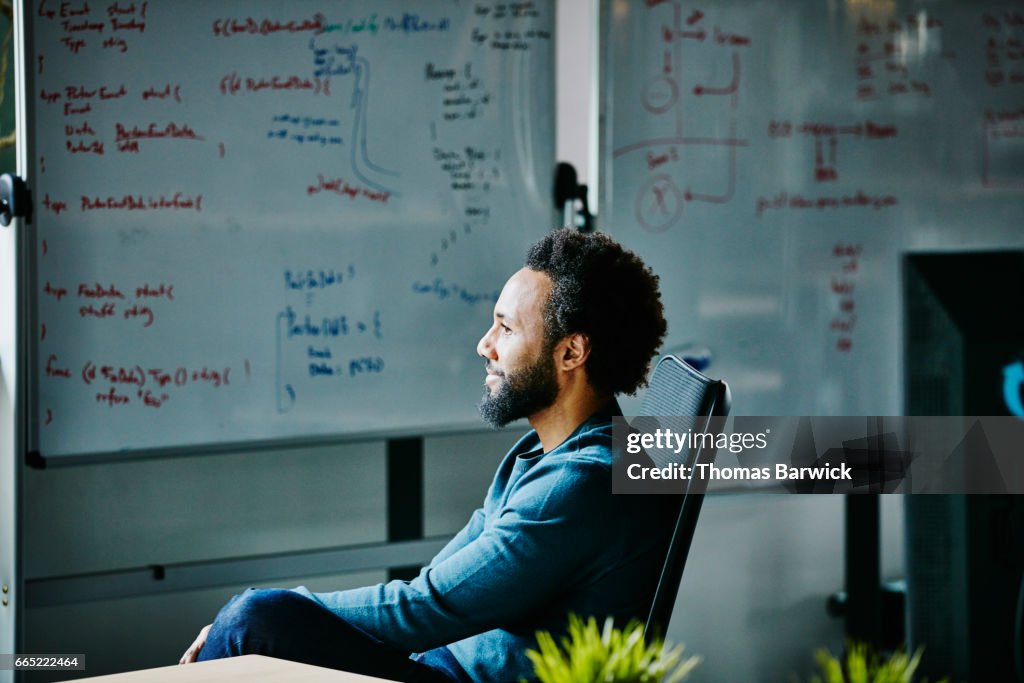 Smiling engineer at workstation in high tech office
