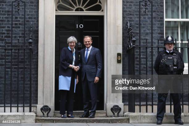 British Prime Minister, Theresa May, greets The President of the European Council, Donald Tusk, on the doorstep of 10 Downing Street on April 6, 2017...