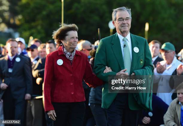 Chairman of Augusta National Golf Club William Porter 'Billy' Payne and Kathleen 'Kit' Palmer place a Green Jacket on a chair in honor of Arold...