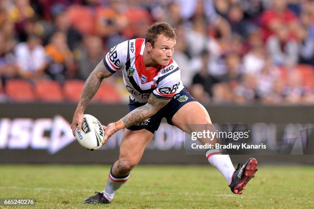 Jake Friend of the Roosters passes the ball during the round six NRL match between the Brisbane Broncos and the Sydney Roosters at Suncorp Stadium on...