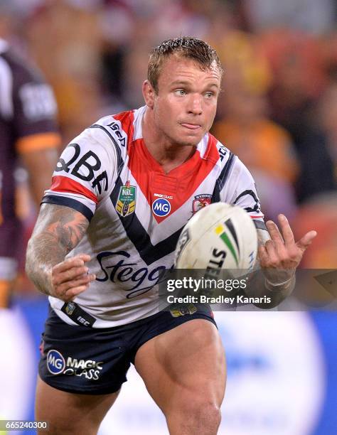 Jake Friend of the Roosters passes the ball during the round six NRL match between the Brisbane Broncos and the Sydney Roosters at Suncorp Stadium on...