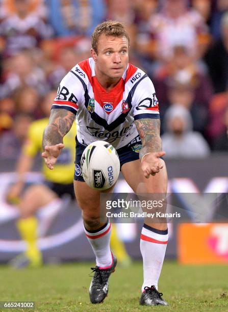 Jake Friend of the Roosters passes the ball during the round six NRL match between the Brisbane Broncos and the Sydney Roosters at Suncorp Stadium on...