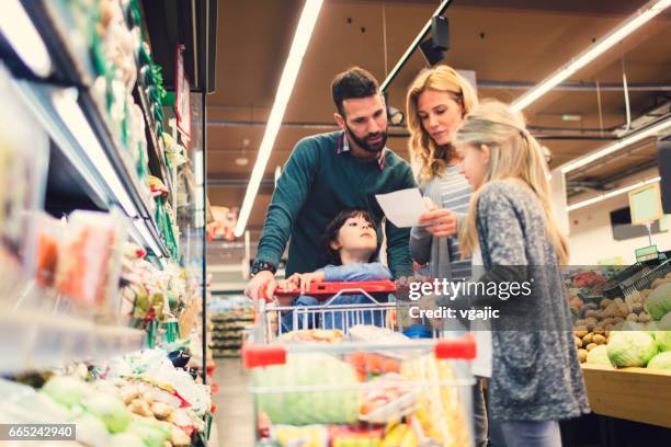 family shopping in supermarket - list imagens e fotografias de stock