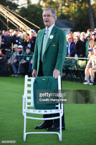 Chairman of Augusta National Golf Club William Porter 'Billy' Payne stands next to a Green Jacket on a chair in honor of Arold Palmer during the...