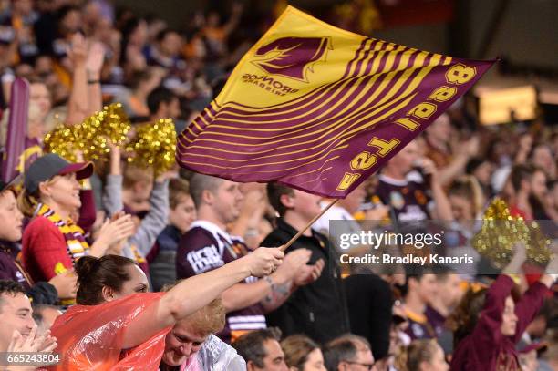 Broncos fans celebrate after a try during the round six NRL match between the Brisbane Broncos and the Sydney Roosters at Suncorp Stadium on April 6,...