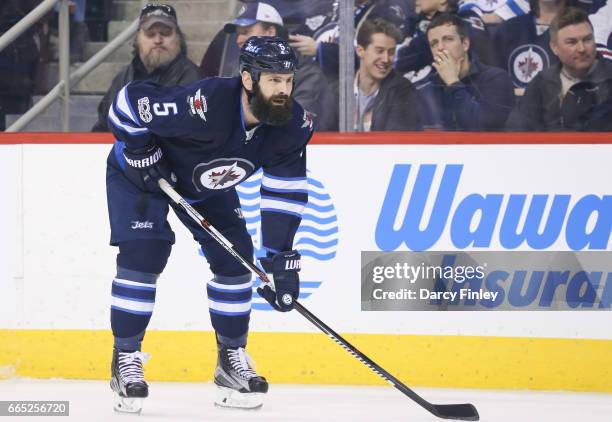 Mark Stuart of the Winnipeg Jets gets set during a first period face-off against the Ottawa Senators at the MTS Centre on April 1, 2017 in Winnipeg,...