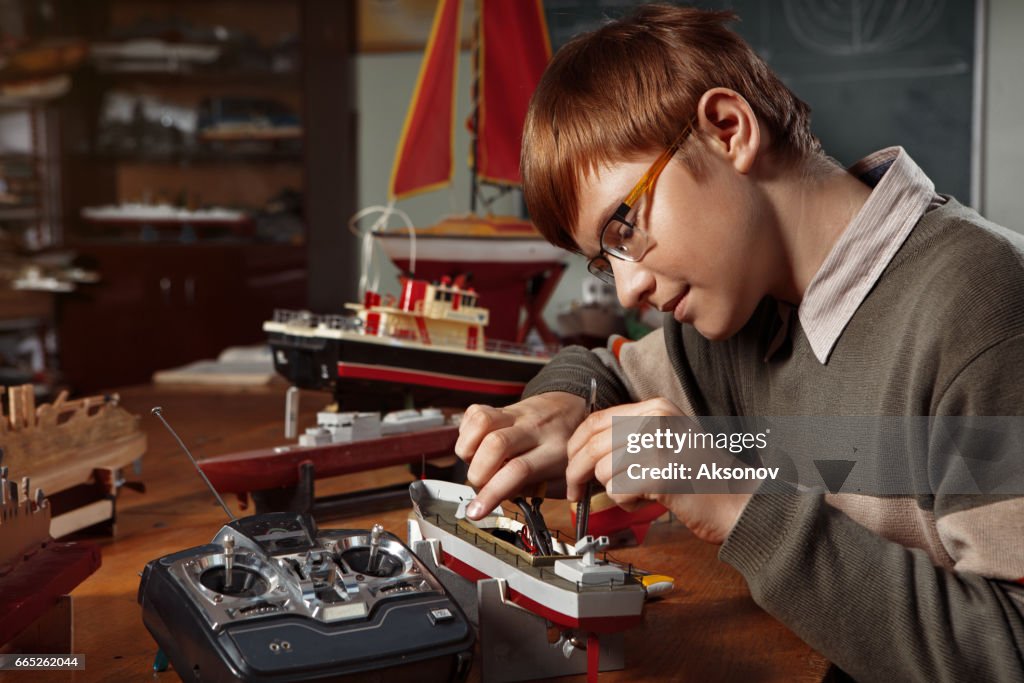 Boy Making Model Kit Young Boy Constructing A Ship Model High-Res Stock Photo - Getty Images