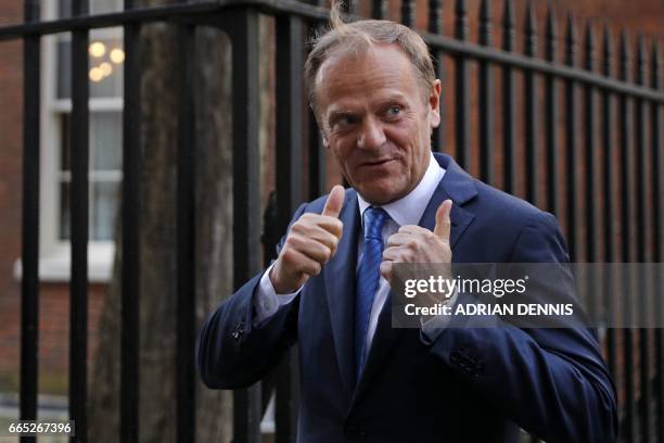 European Council President Donald Tusk gestures to members of the media as he leaves 10 Downing street after talks with British Prime Minister...