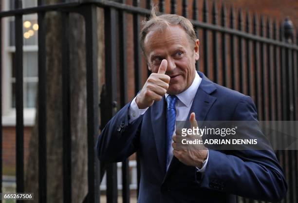 European Council President Donald Tusk gestures to members of the media as he leaves 10 Downing street after talks with British Prime Minister...