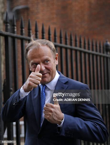 European Council President Donald Tusk gestures to members of the media as he leaves 10 Downing street after talks with British Prime Minister...