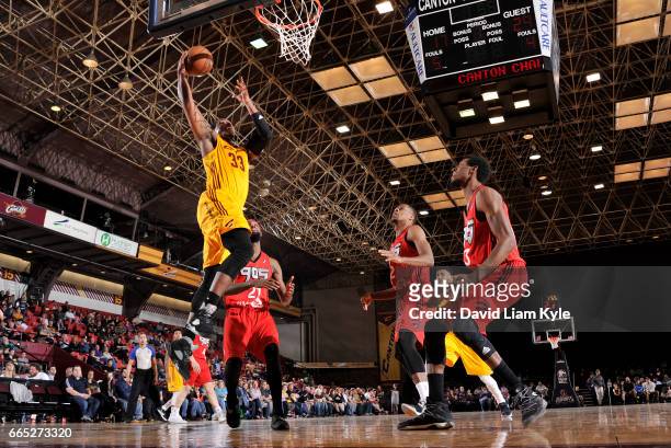 Jonathan Holmes of the Canton Charge goes up for the dunk against Antwaine Wiggins of the Raptors 905 at the Canton Memorial Civic Center on April 5,...