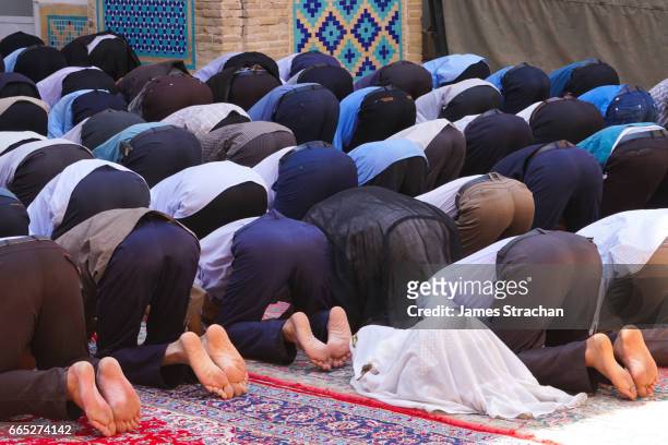 men and little girl praying, men's section, jameh mosque, varzaneh, iran - girl praying stock pictures, royalty-free photos & images