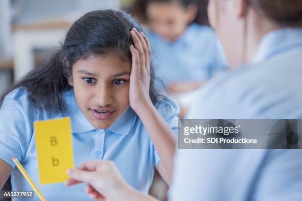 teacher uses flashcards with female student - flash card stock pictures, royalty-free photos & images