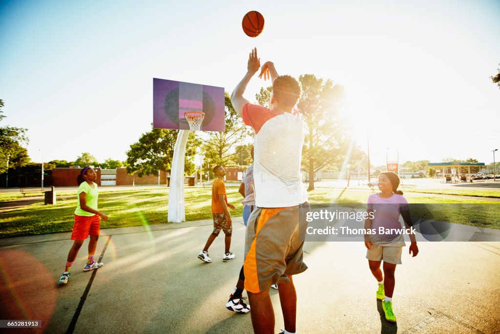 Basketball Player Taking Shot Over Defender High-Res Stock Photo