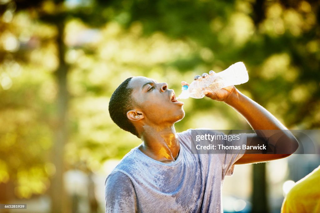 Basketball player drinking water after game
