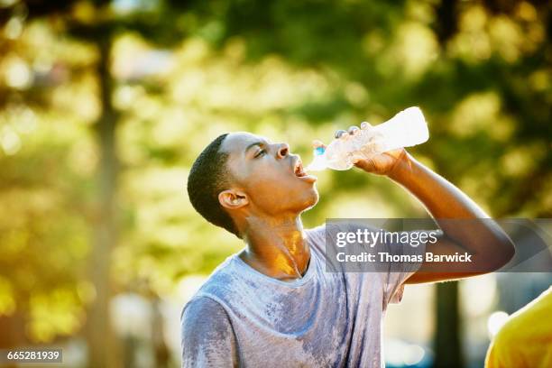 basketball player drinking water after game - boy drinking water stock pictures, royalty-free photos & images