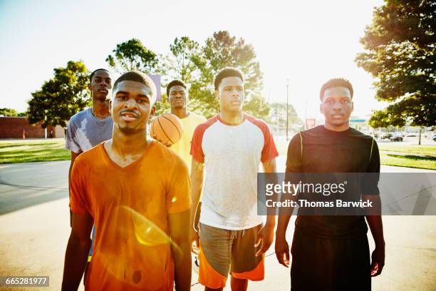 group of friends on basketball court after game - five friends unity stock pictures, royalty-free photos & images