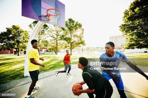group of friends playing pickup up basketball game - blocking sports activity stock pictures, royalty-free photos & images