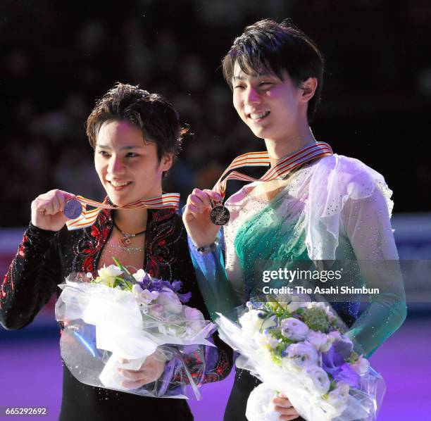 Gold medalist Yuzuru Hanyu and silver medalist Shoma Uno pose for photographs at the medal ceremony for the Men's Singles during day four of the...