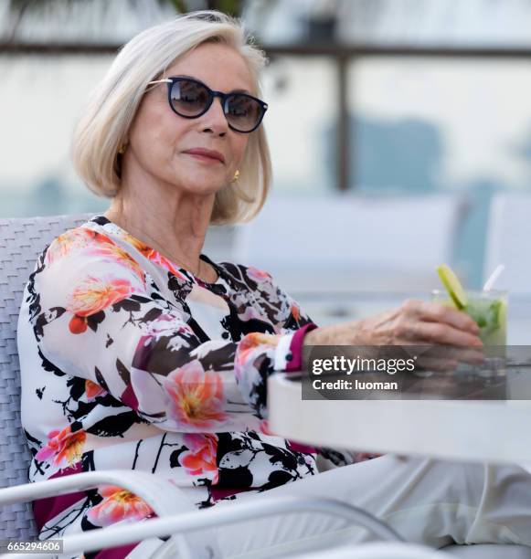 elegant old lady drinking a caipirinha - caipirinha stock pictures, royalty-free photos & images