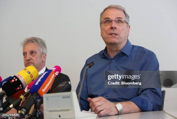 Wolfgang Schaefer-Klug, chairman of the work council at Adam Opel AG, right, speaks as Herrn Uwe Schuetz, secretary of the IG Metall labor union,...