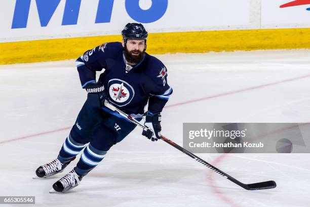 Mark Stuart of the Winnipeg Jets keeps an eye on the play during second period action against the Ottawa Senators at the MTS Centre on April 1, 2017...