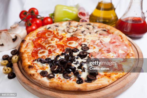 pizza quatro stagioni on a white background with ingredients around - stagioni stock pictures, royalty-free photos & images