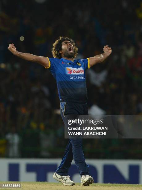 Sri Lankan cricketer Lasith Malinga celebrates taking the hat trick wicket to dismiss Bangladesh cricketer Mehedi Hasan during the second T20...