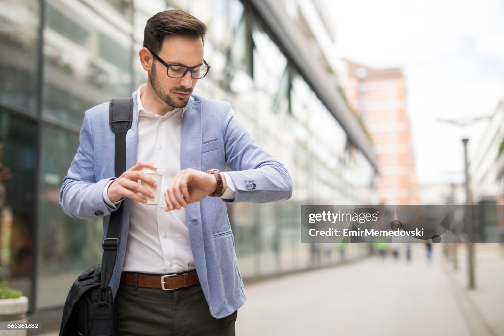 Businessman checking the time on his wrist watch