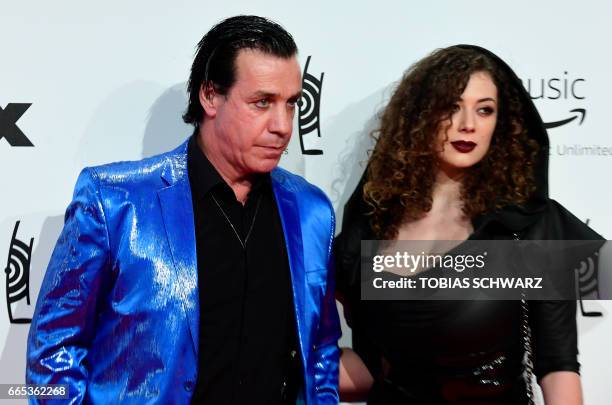German singer of group Rammstein, Till Lindemann, and friend Leila Lowfire arrive for the 2017 Echo Music Awards in Berlin, on April 6, 2017. / AFP...