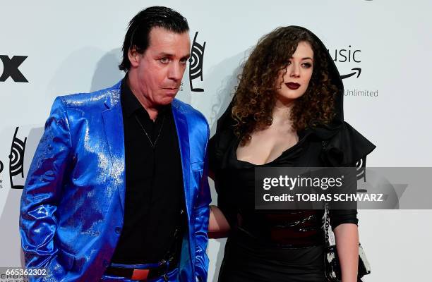 German singer of group Rammstein, Till Lindemann, and friend Leila Lowfire arrive for the 2017 Echo Music Awards in Berlin, on April 6, 2017. / AFP...