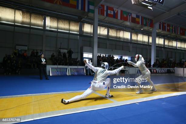 Blake Broszus of Canada fences Wallerand Roger of France during the Junior Men's Foil Event at the Junior and Cadet World Fencing Championships on...