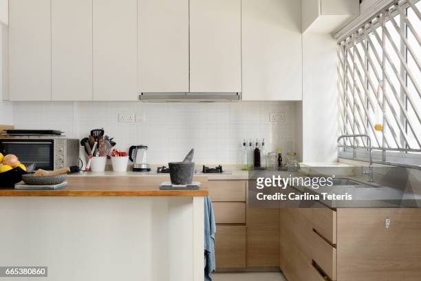home kitchen with white cabinets and an island - isla de cocina fotografías e imágenes de stock