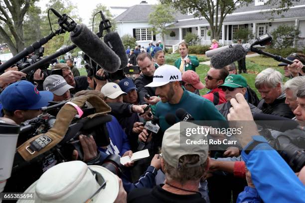 Dustin Johnson of the United States talks to the media announcing his withdrawl during the first round of the 2017 Masters Tournament at Augusta...