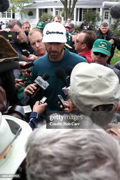 Dustin Johnson of the United States talks to the media announcing his withdrawl during the first round of the 2017 Masters Tournament at Augusta...