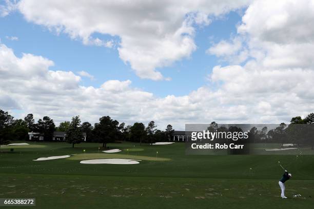 Dustin Johnson of the United States plays a shot on the practice range prior to announcing his withdrawl during the first round of the 2017 Masters...