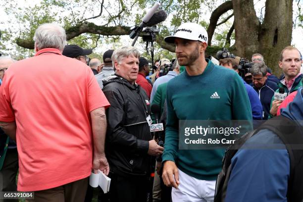 Dustin Johnson of the United States walks off after announcing his withdrawl to the media during the first round of the 2017 Masters Tournament at...