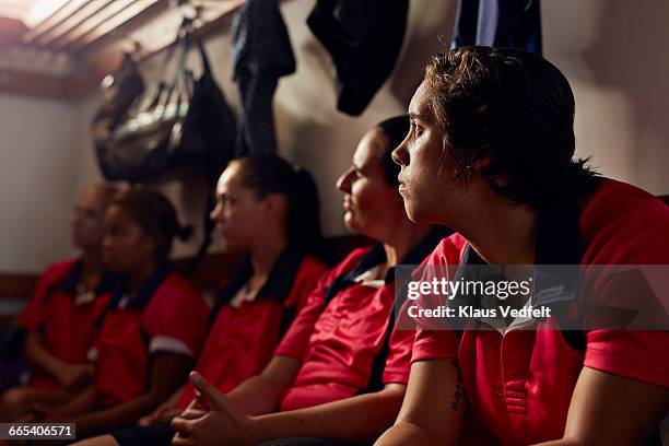 rugby players listening to coach in changing room - umkleideraum stock-fotos und bilder
