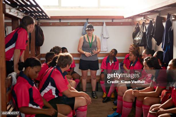 rugby players listening to coach in changing room - sports team work stock pictures, royalty-free photos & images