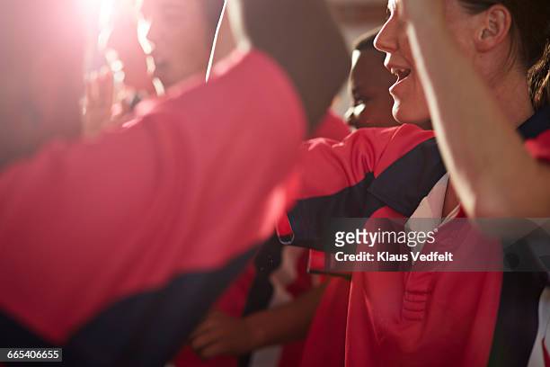 close-up of rugby team cheering after game - super rugby stock-fotos und bilder