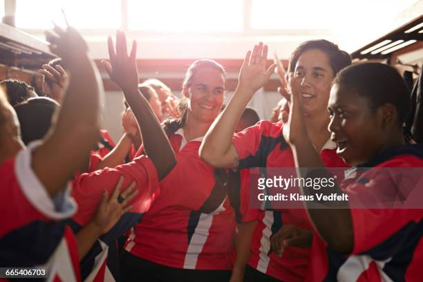 rugby team doing high fives after game - rugby sport stock-fotos und bilder