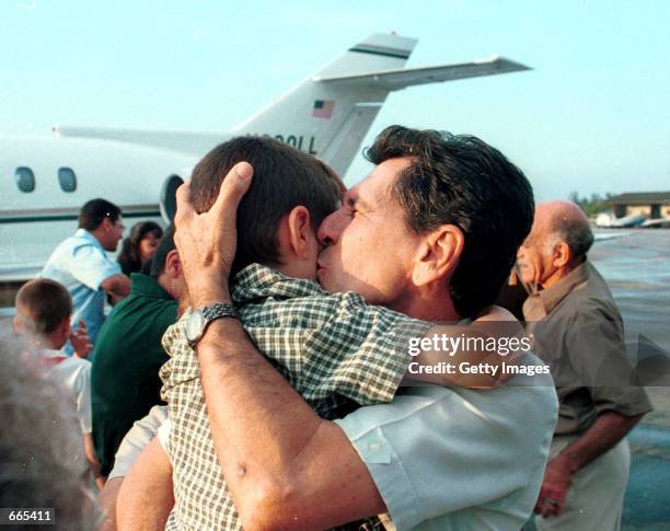 Elian Gonzalez is greeted by his grandfather Orlando Betancourt on his arrival to Havana, Cuba June 28, 2000. Elian left the United States for Cuba,...