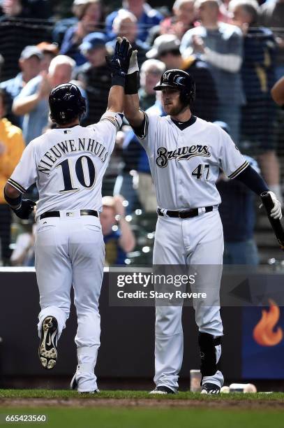 Kirk Nieuwenhuis of the Milwaukee Brewers is congratulated by Jett Bandy following a seventh inning home run against the Colorado Rockies at Miller...