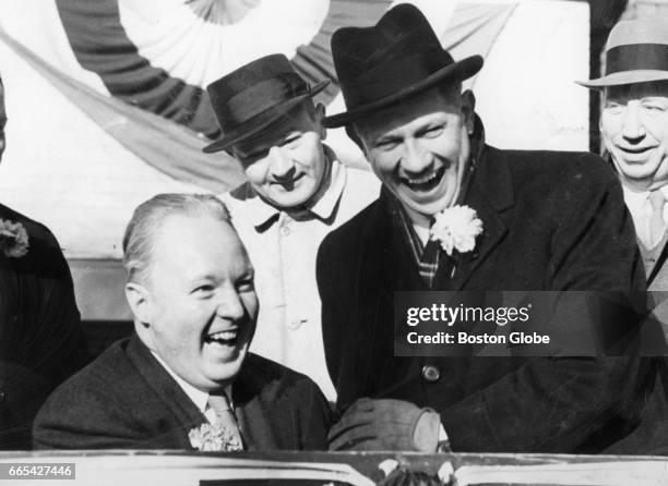 Boston Mayor John F. Collins, left, and Massachusetts Governor John A. Volpe watch the St. Patrick's Day Parade in South Boston on Mar. 17, 1961.