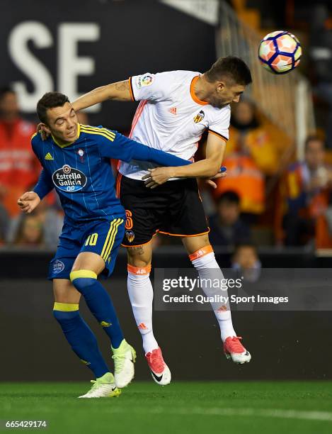 Guillherme Siqueira of Valencia competes for the ball with Iago Aspas of Celta de Vigo during the La Liga match between Valencia CF and RC Celta de...