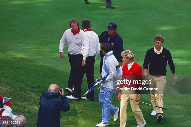 American professional golfer Craig Stadler is consoled by team-mate Lee Trevino after missing a key 18-inch putt at the 18th, during the 1985 Ryder...