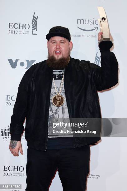 British singer Rag'n'Bone Man poses with his award at the Echo award winners board on April 6, 2017 in Berlin, Germany.