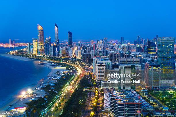 abu dhabi skyline and corniche at night - abu dhabi stock pictures, royalty-free photos & images