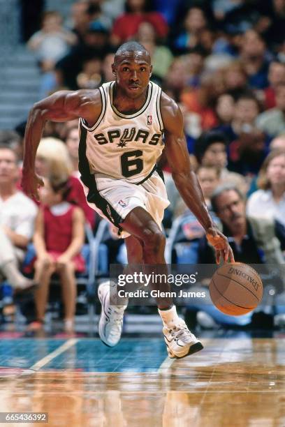 Avery Johnson of the San Antonio Spurs drives against the New York Knicks in a preseason game on October 25, 1997 at the Alamodome in San Antonio,...